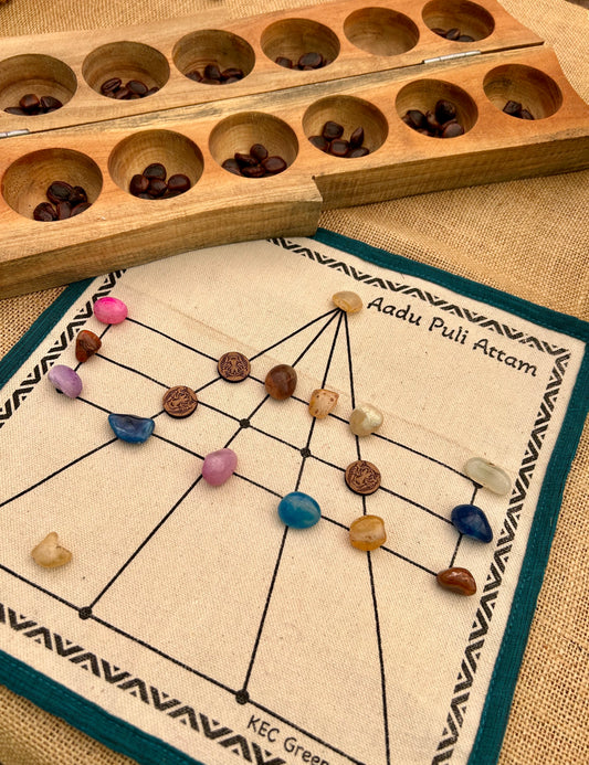 Wooden game board with colored stones on a fabric mat