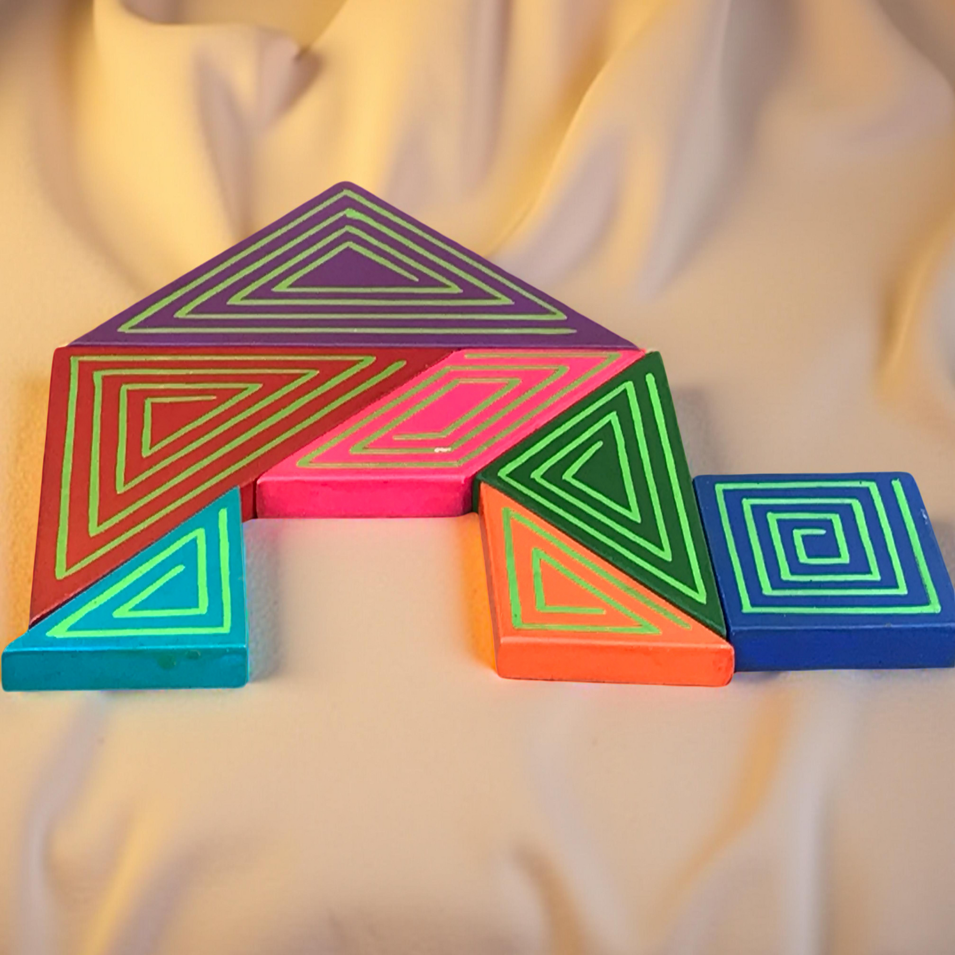 Colorful geometric pieces on a draped fabric background